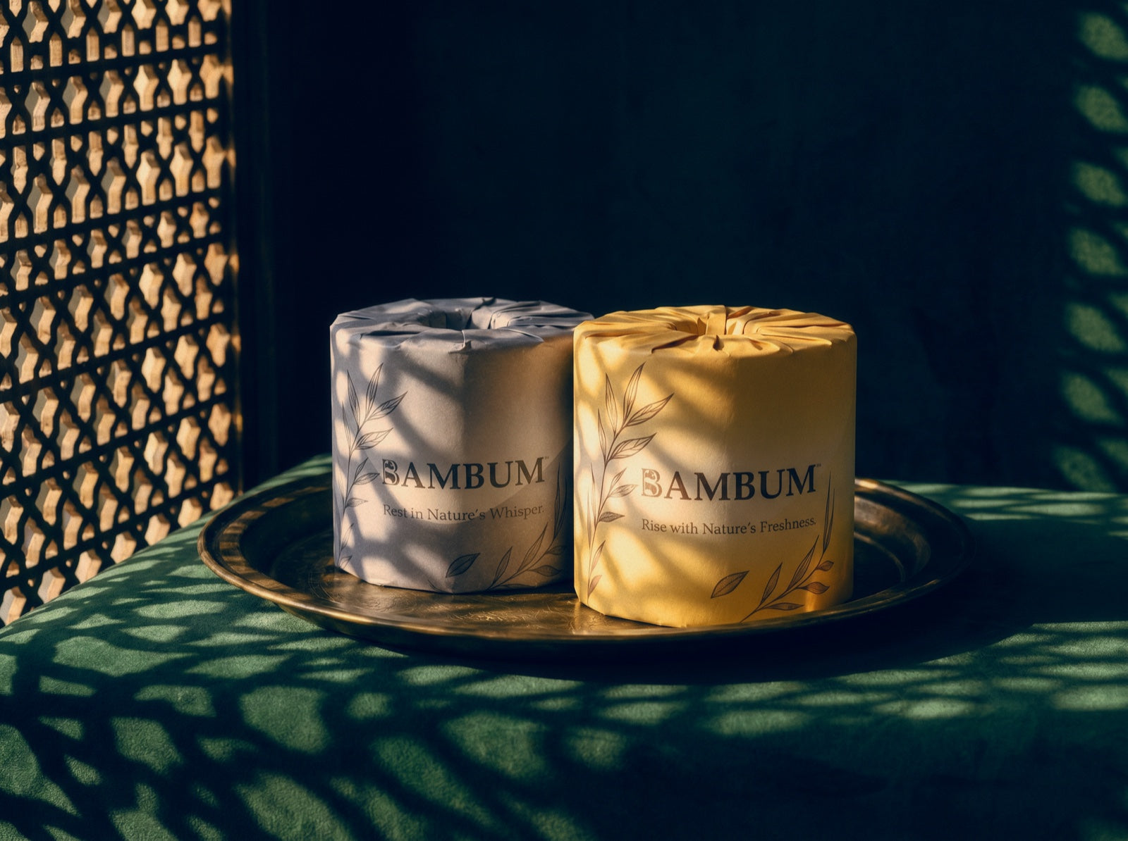 Two BAMBUM two-roll packs on a tray in dappled light